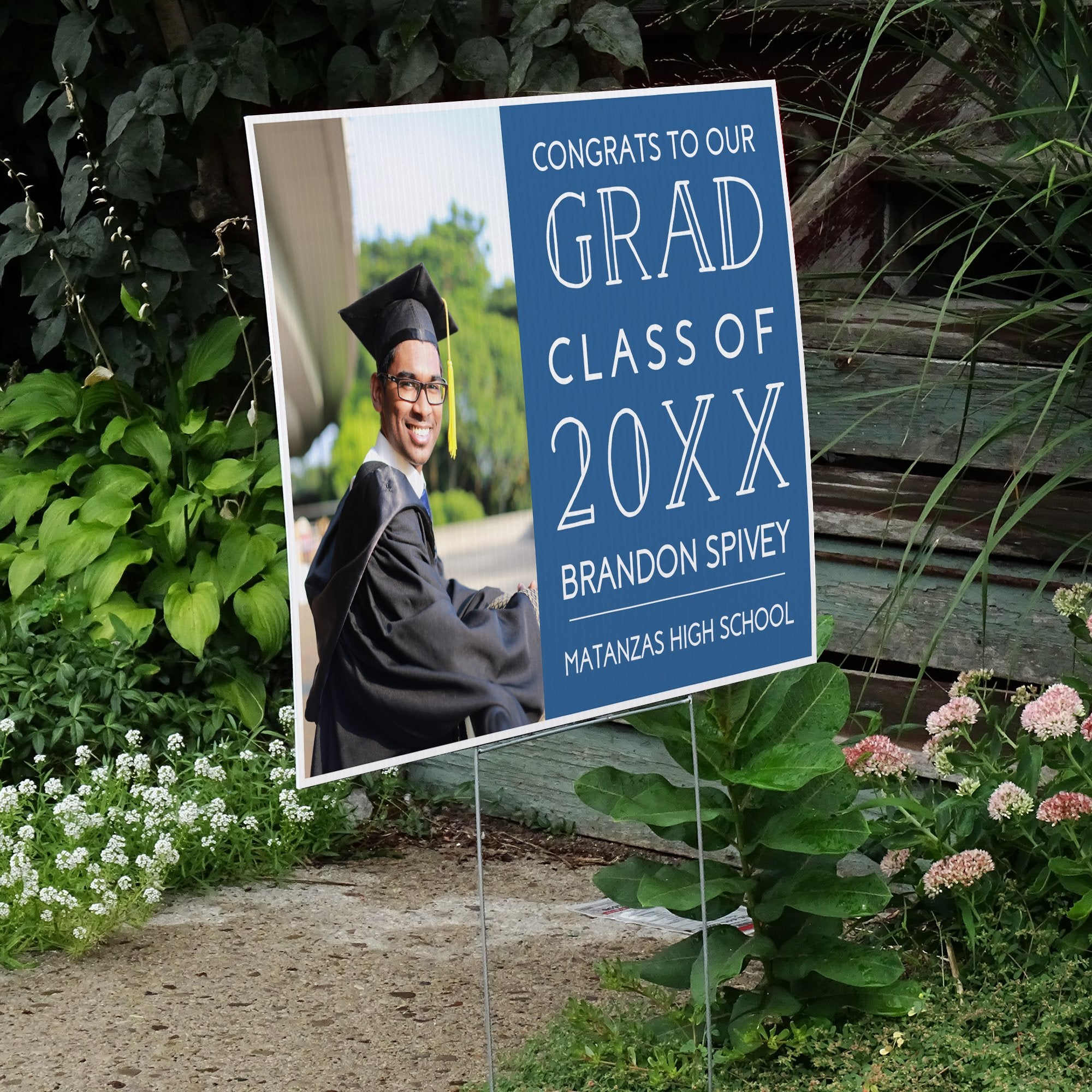 Congrats to our grad graduation yard sign next to stairs