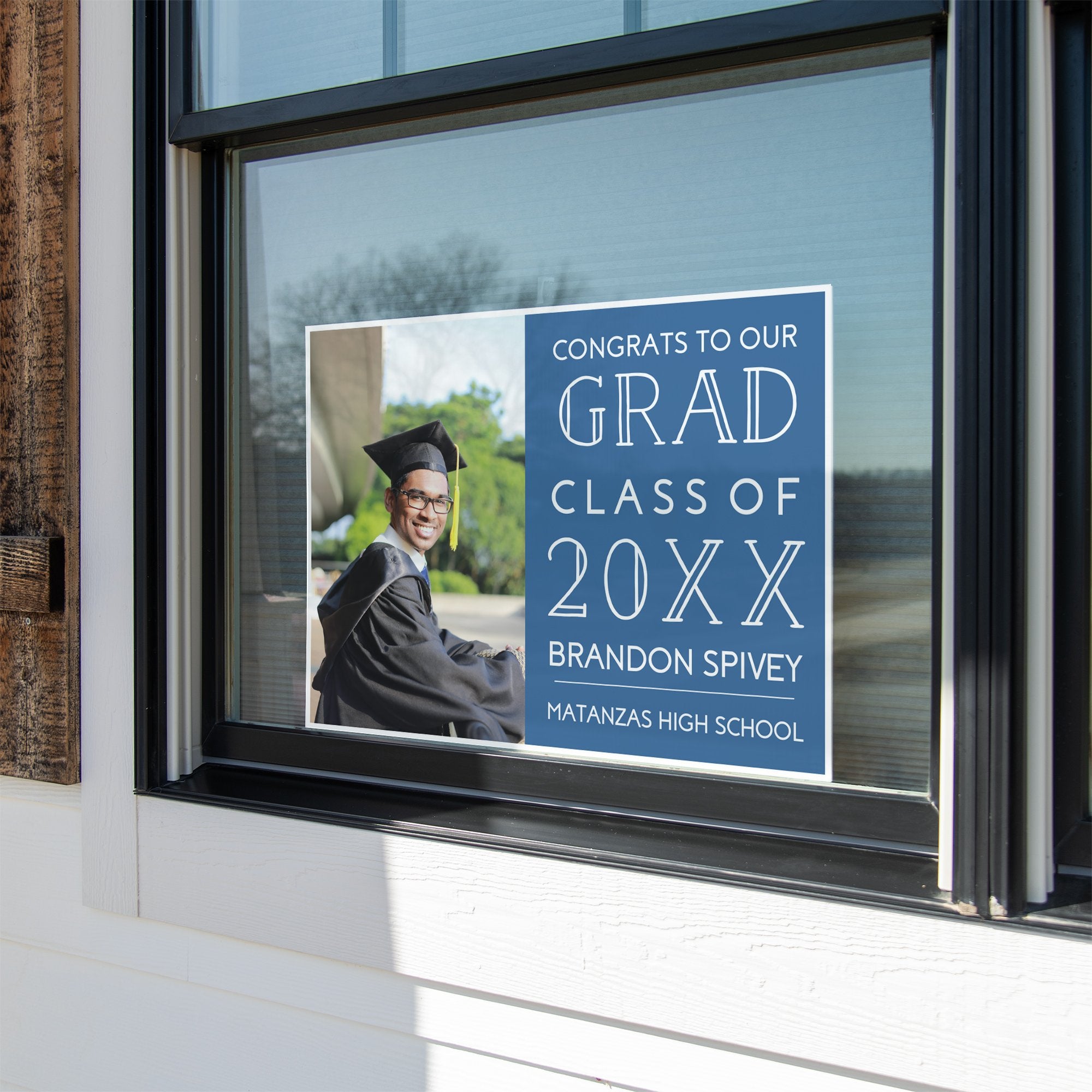 Congrats to our grad graduation yard sign in a window
