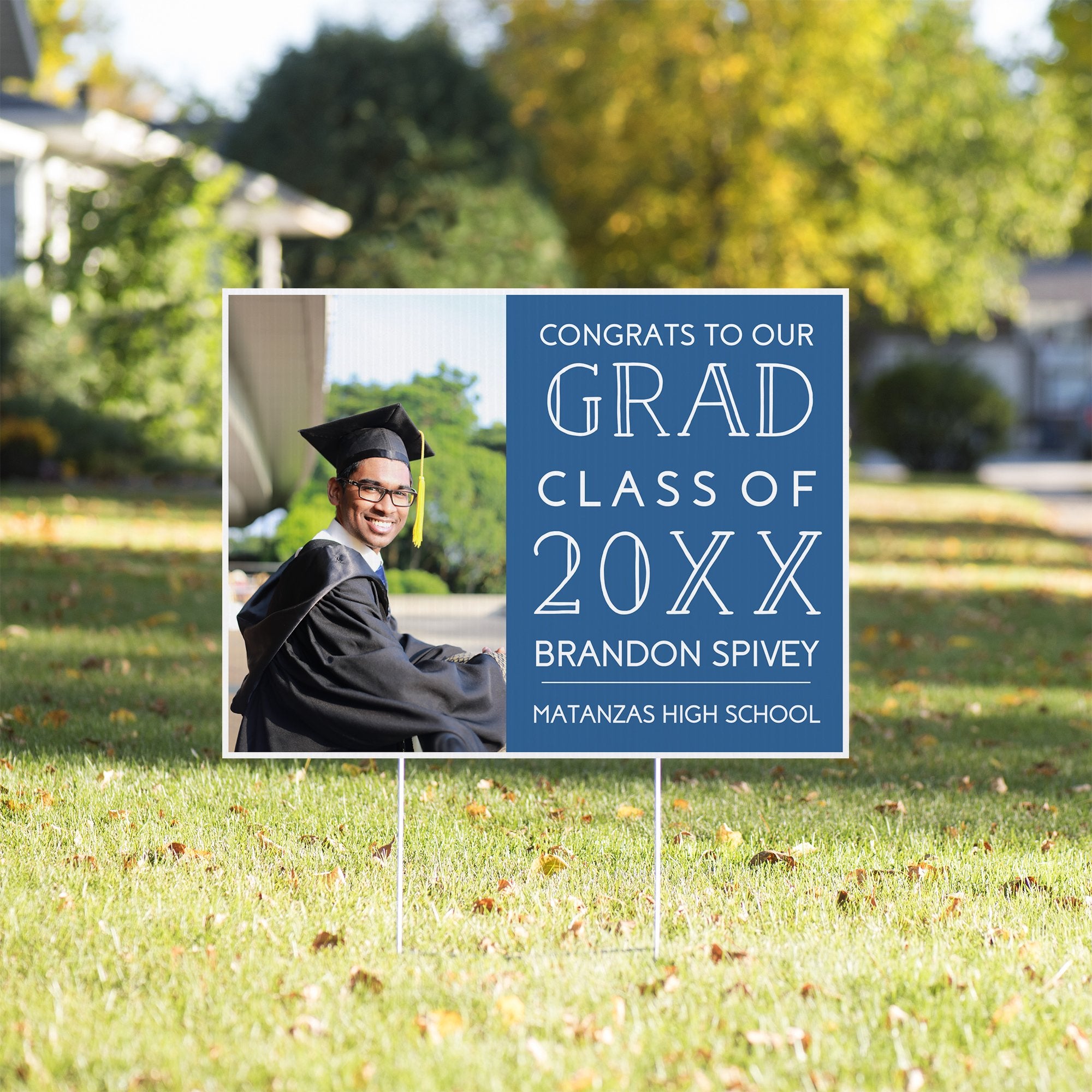 Congrats to our grad graduation yard sign in a sunny yard