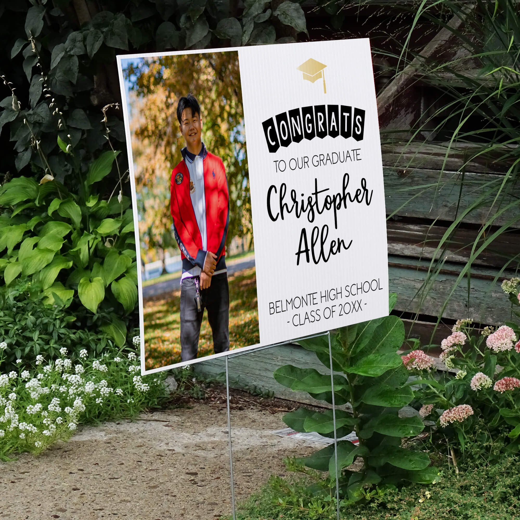 Graduation photo yard sign displayed next to stairs