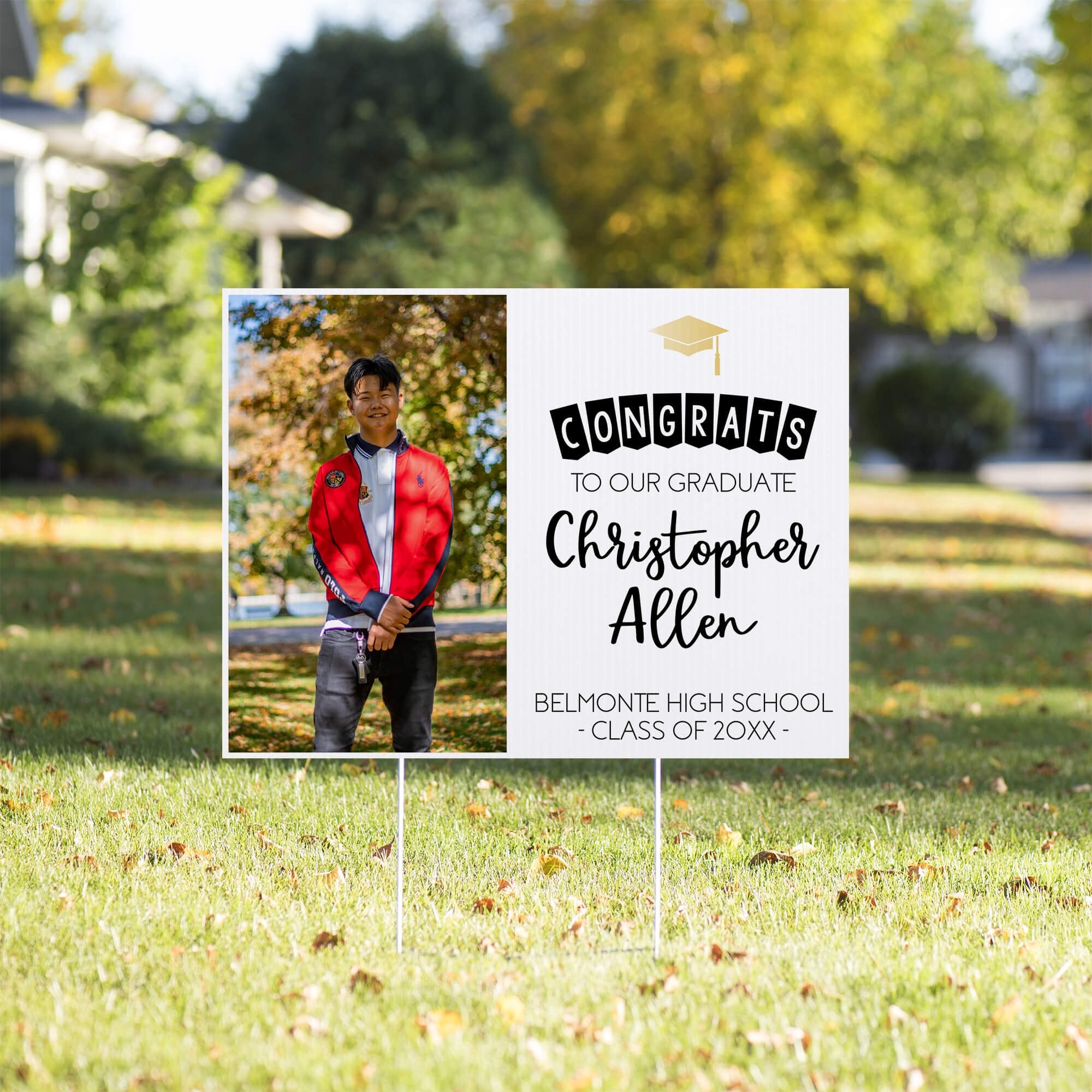 Graduation photo yard sign displayed in a sunny yard