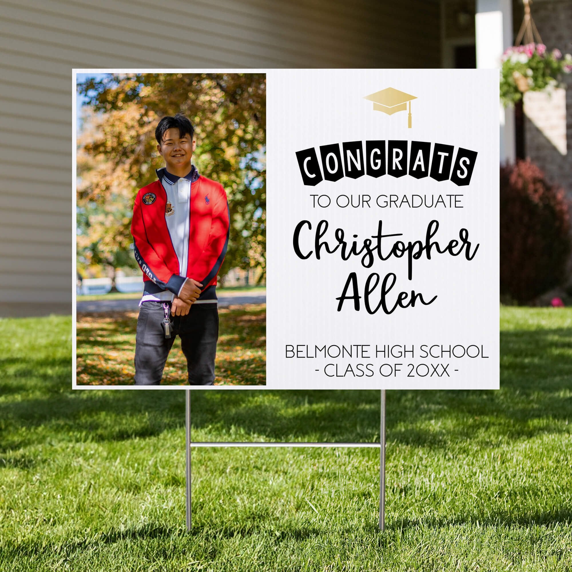 Graduation photo yard sign displayed in a front yard