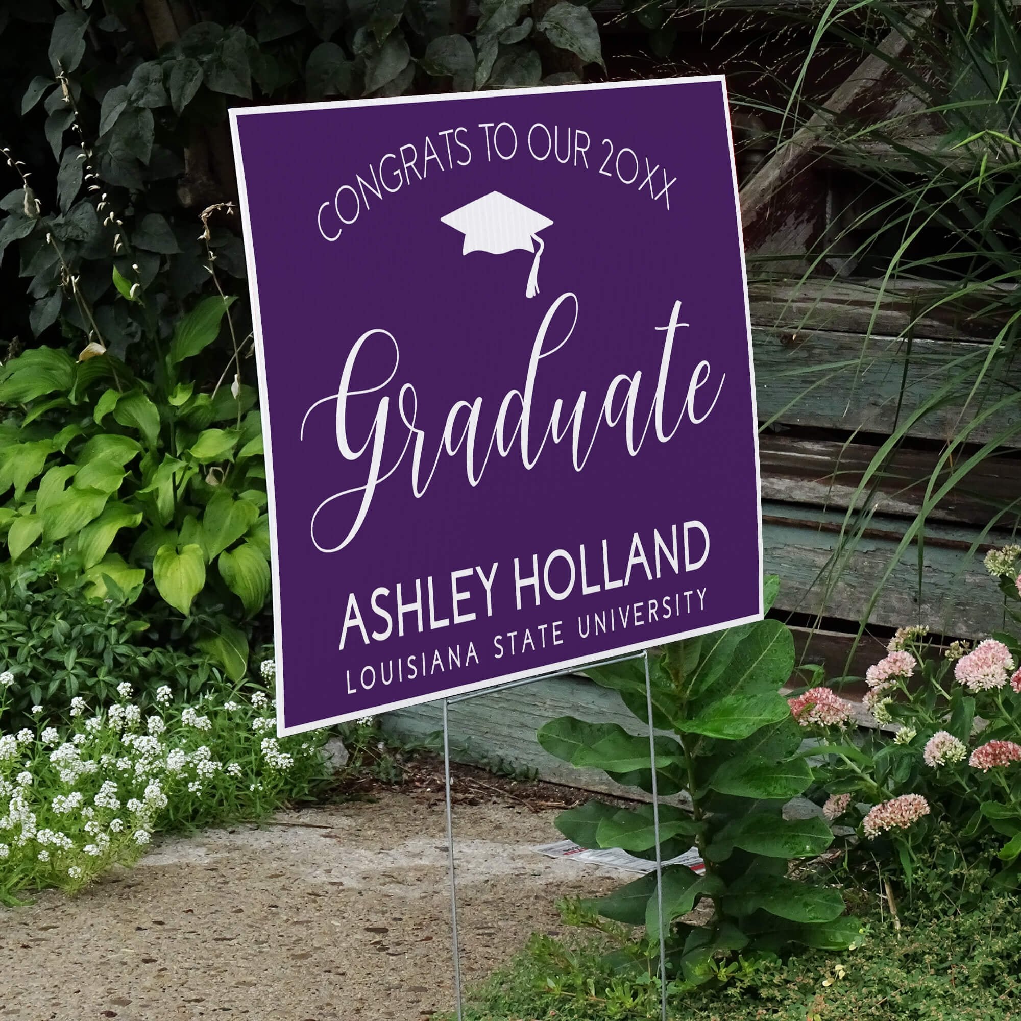 Congrats to our graduate yard sign displayed next to stairs