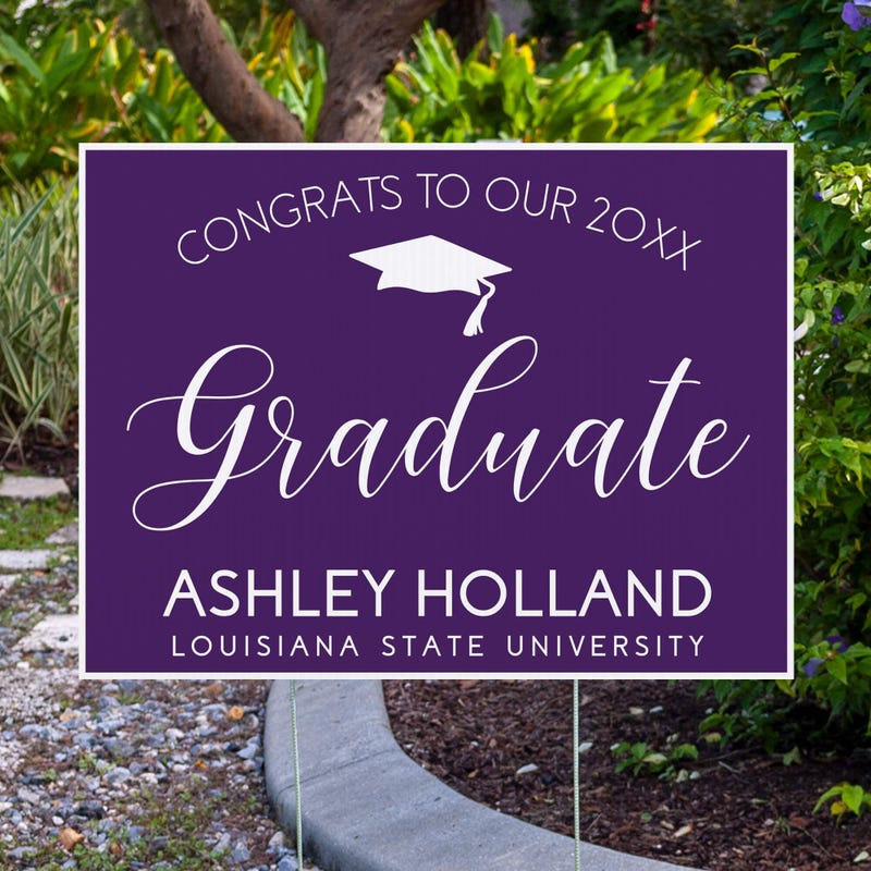 Congrats to our graduate yard sign displayed next to pavement