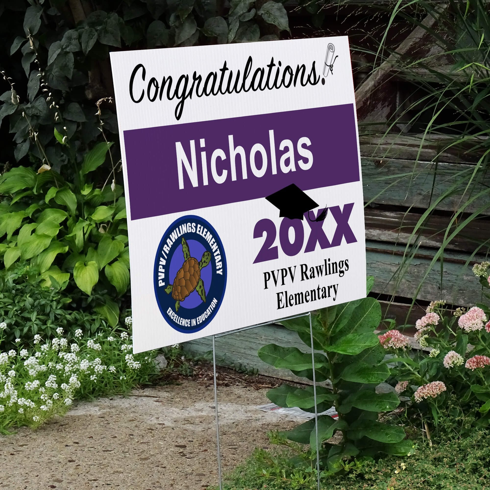 School logo graduation yard sign displayed next to stairs