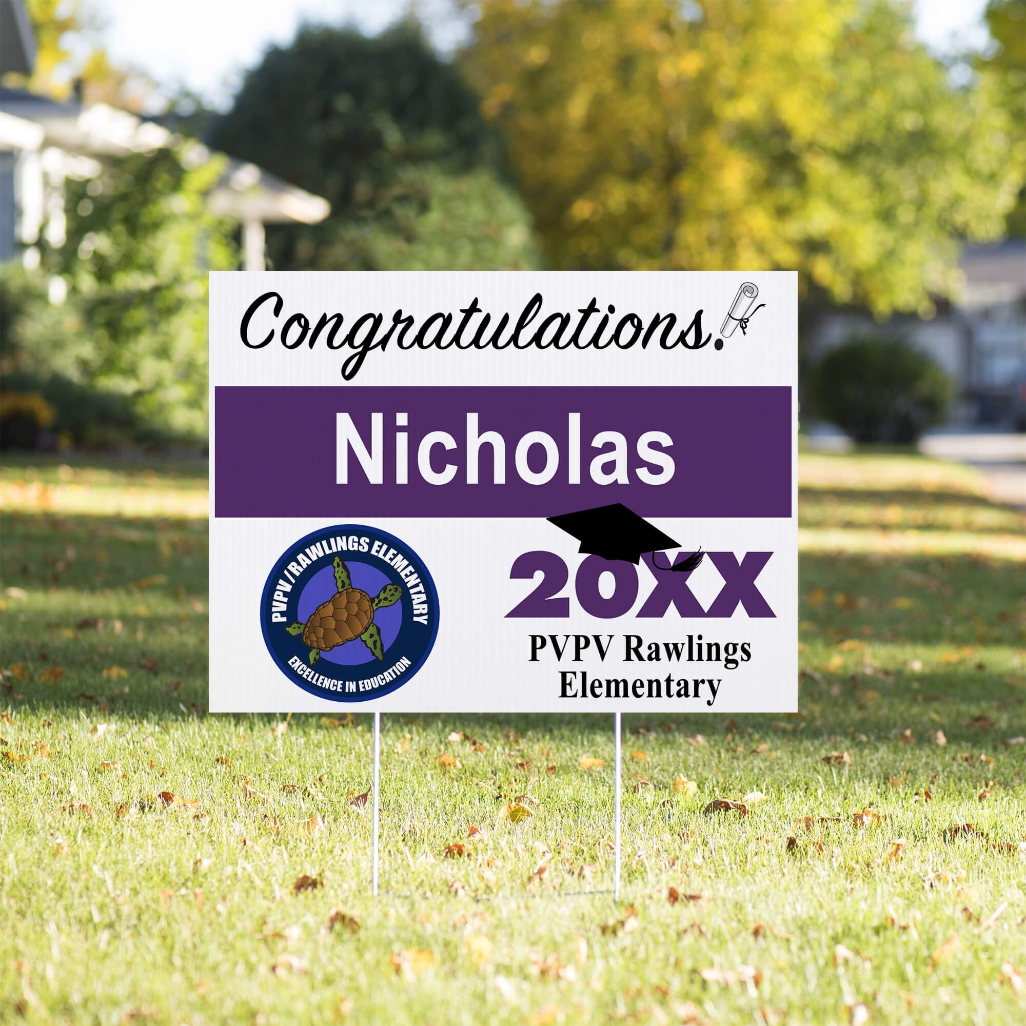 School logo graduation yard sign displayed in a yard