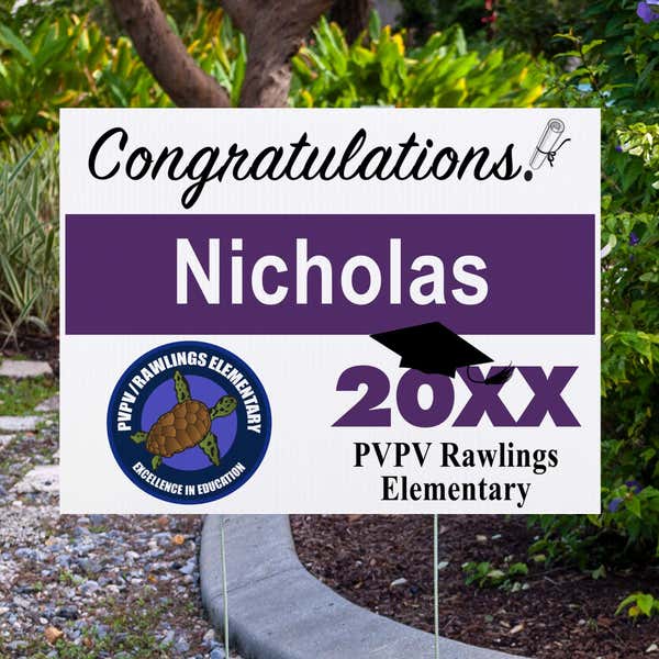 School logo graduation yard sign displayed next to pavement