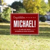 Bold name graduation yard sign displayed in a yard