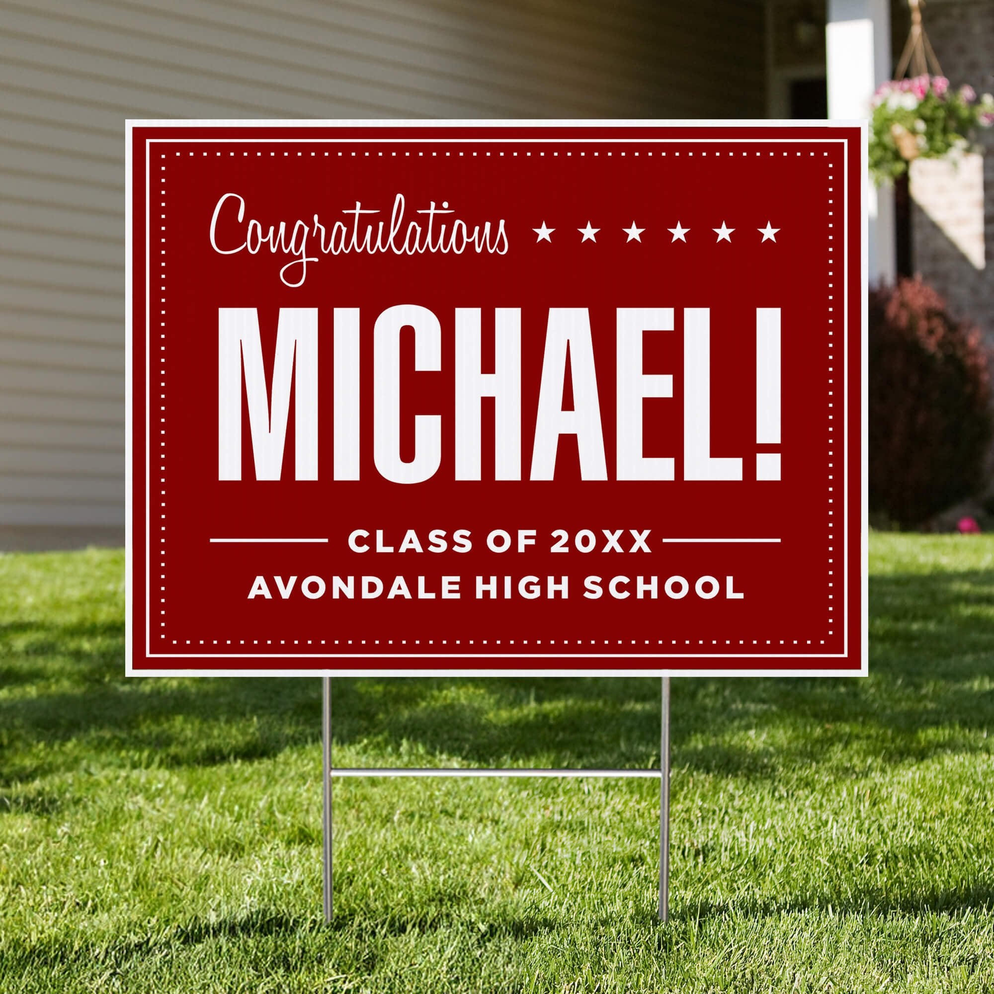 Bold name graduation yard sign displayed in front of a house