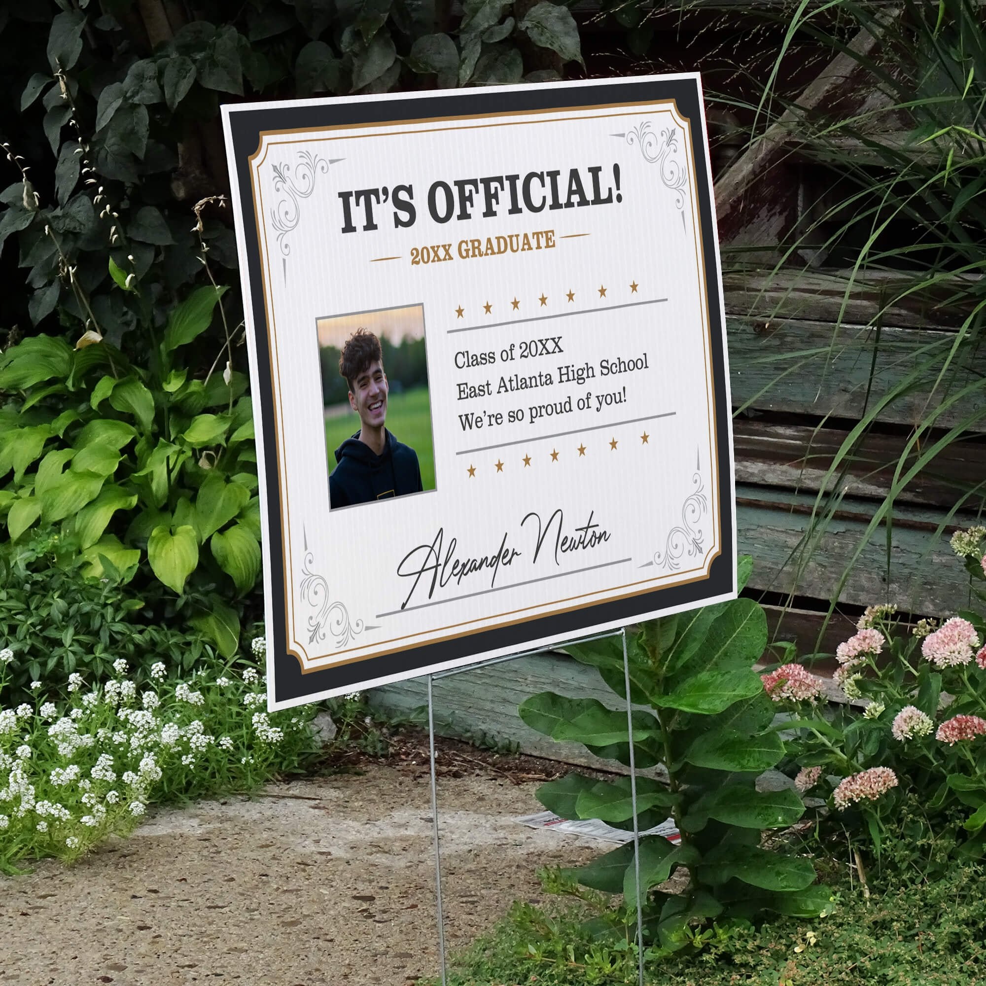 Diploma graduation yard sign displayed next to stairs