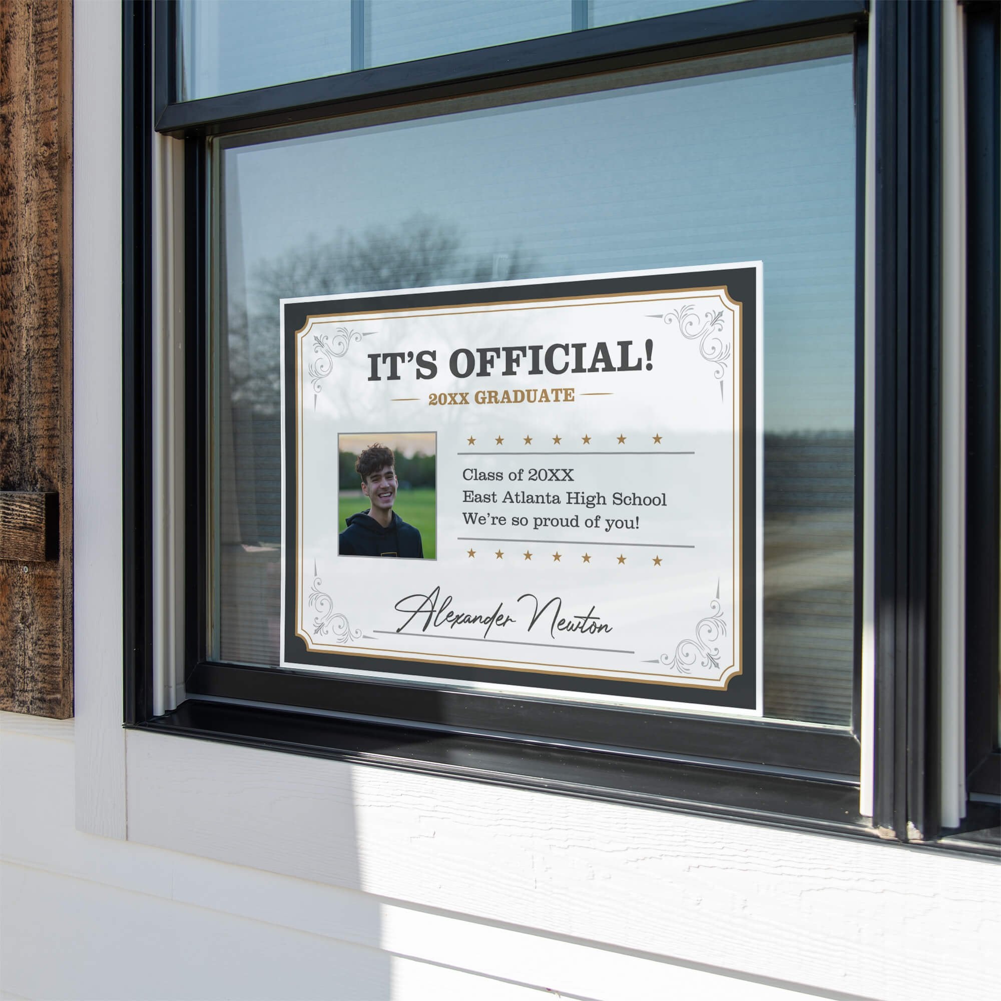 Diploma graduation yard sign displayed in a window