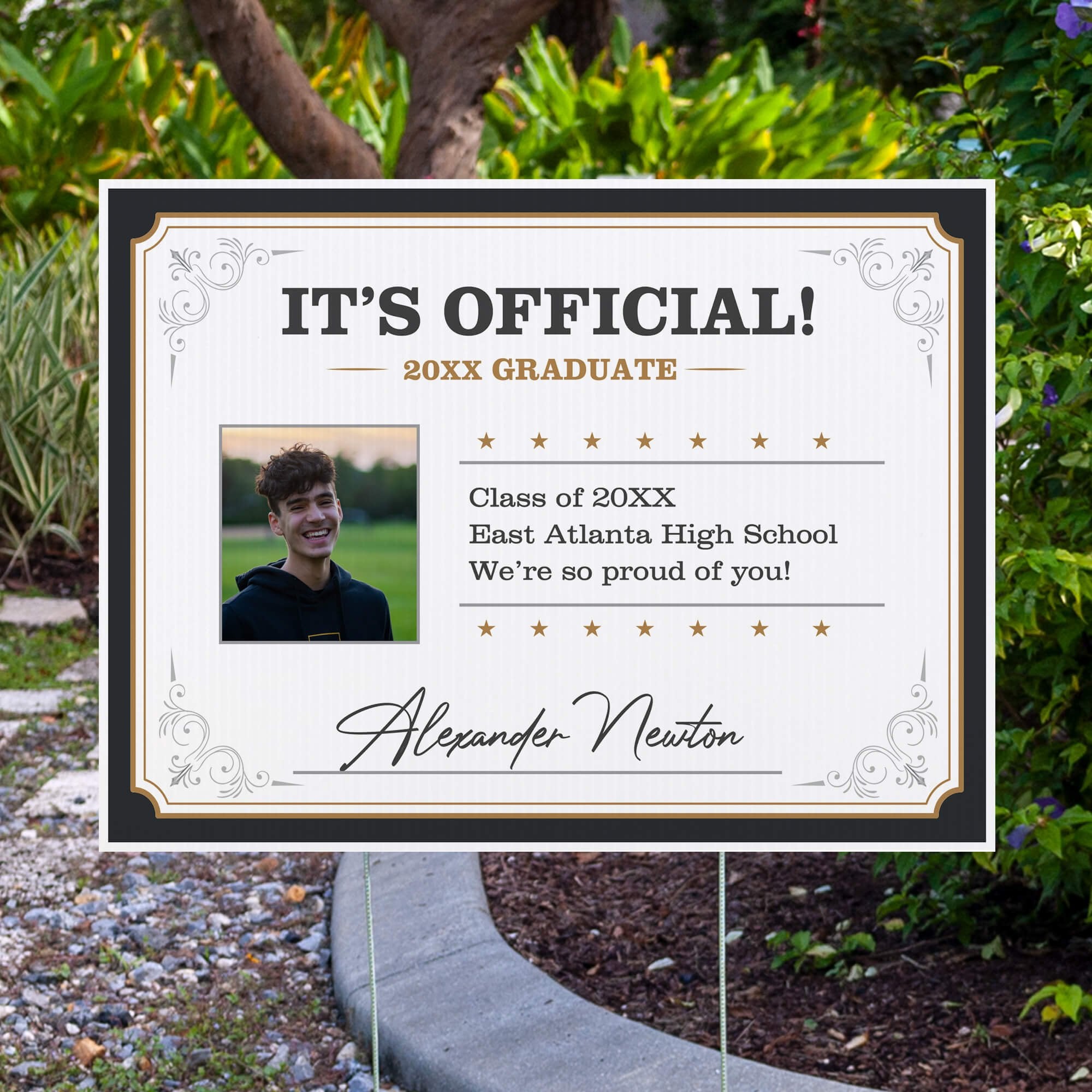 Diploma graduation yard sign displayed next to pavement