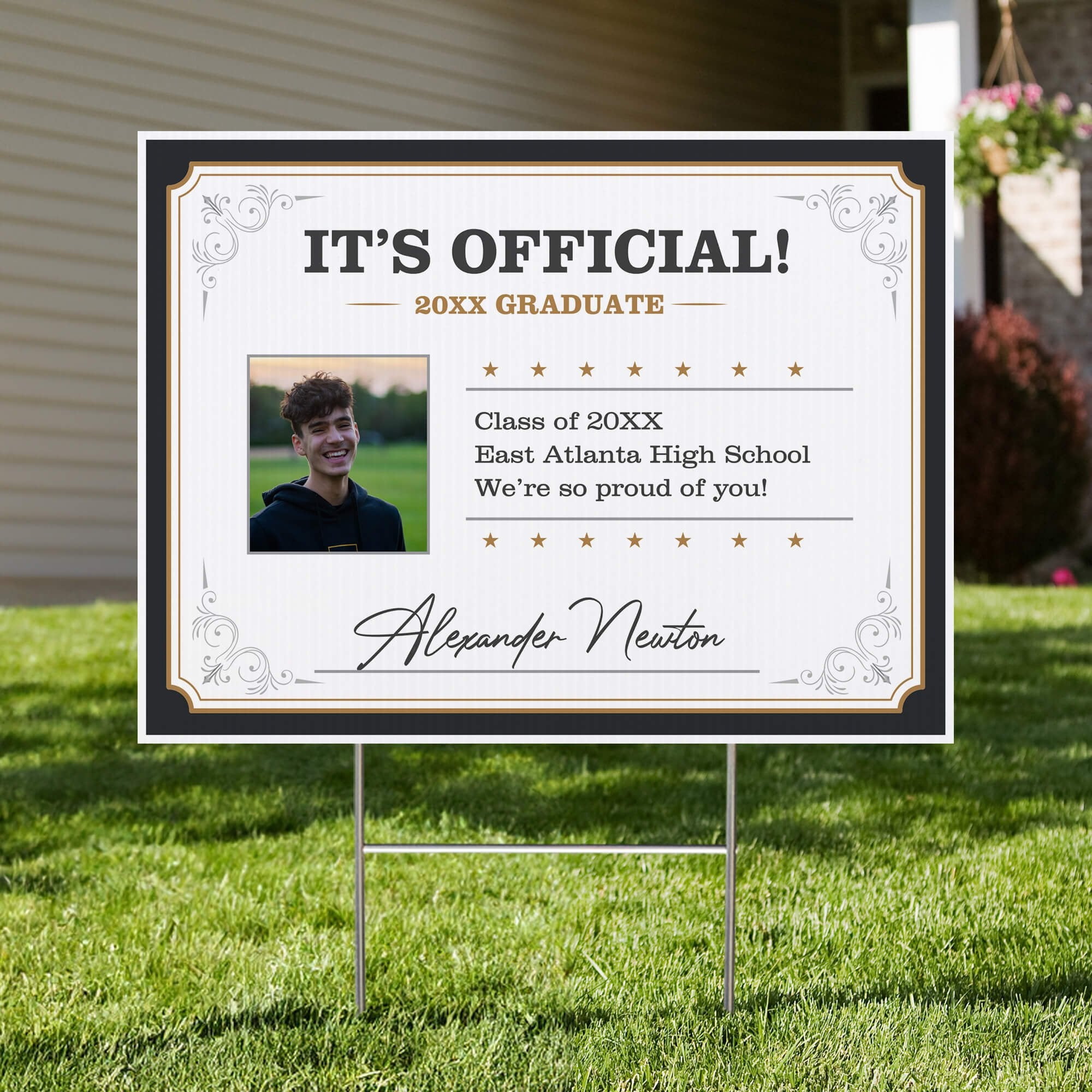 Diploma graduation yard sign displayed in a front yard