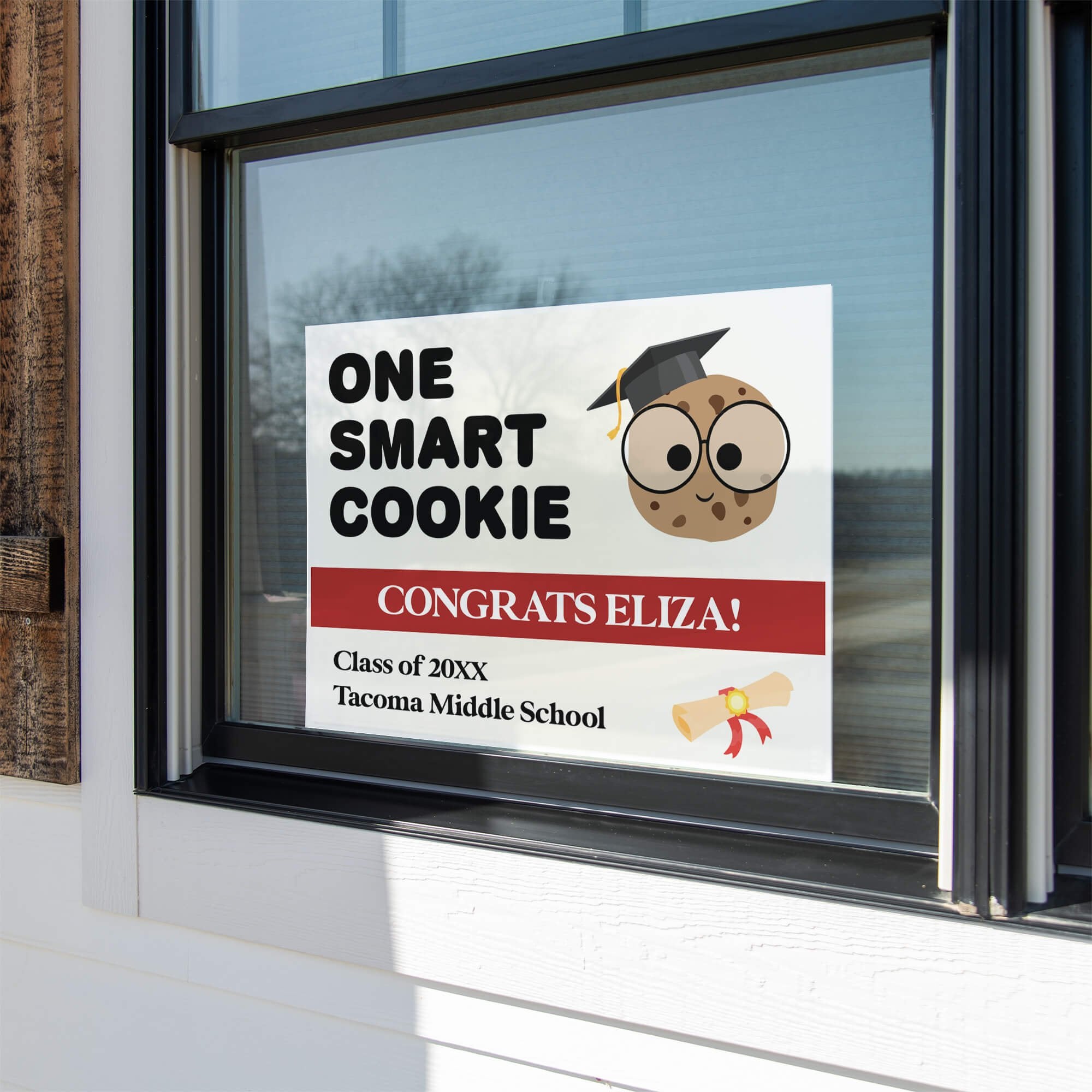 graduation yard sign displayed in a window