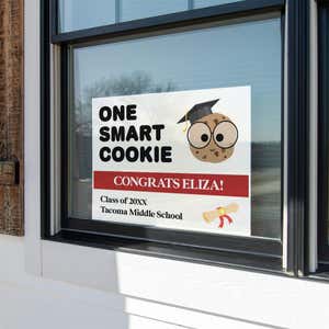 graduation yard sign displayed in a window