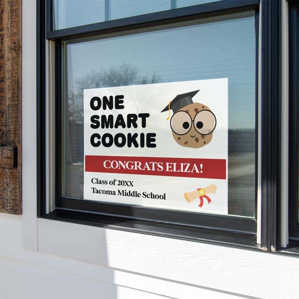 graduation yard sign displayed in a window