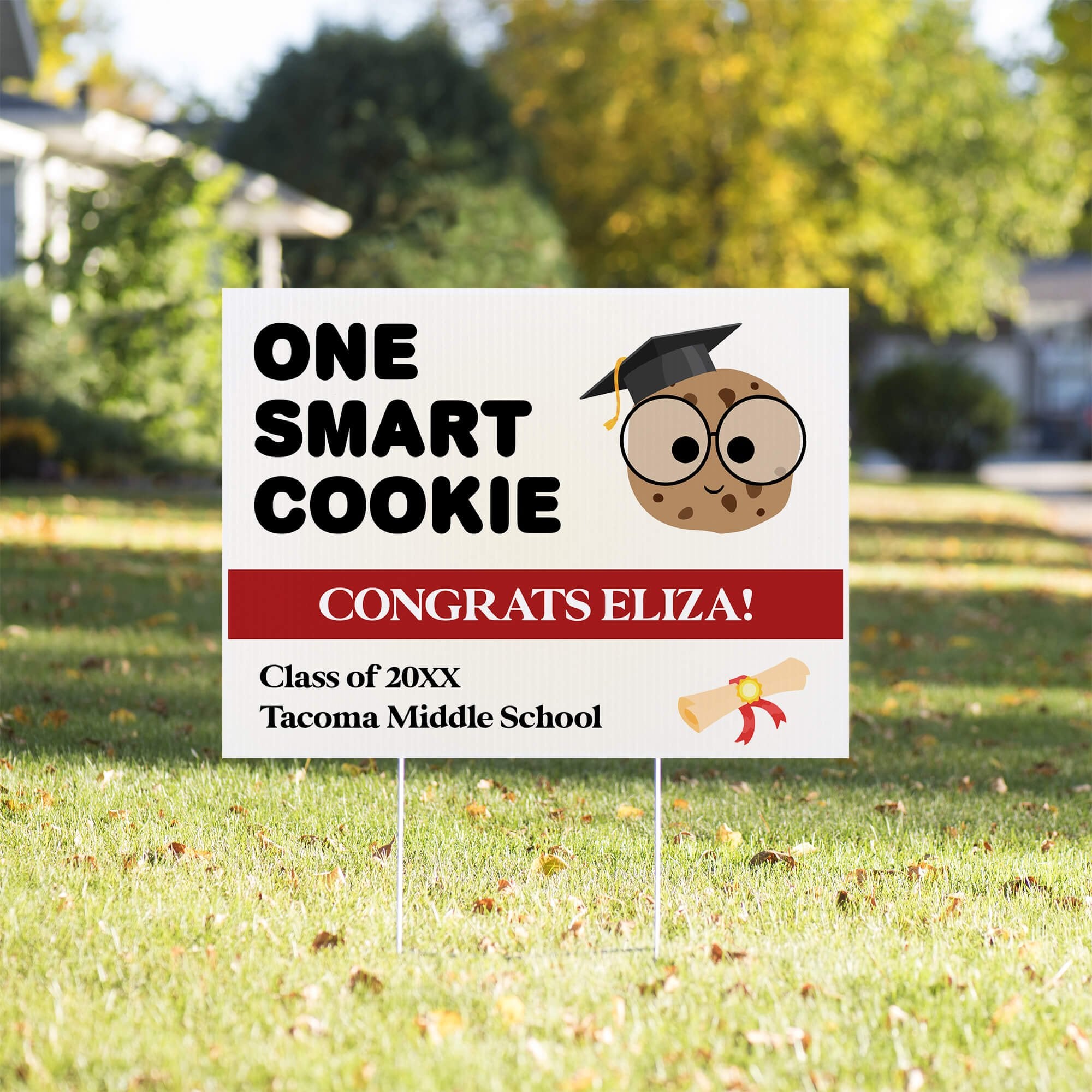 graduation yard sign displayed in a sunny yard
