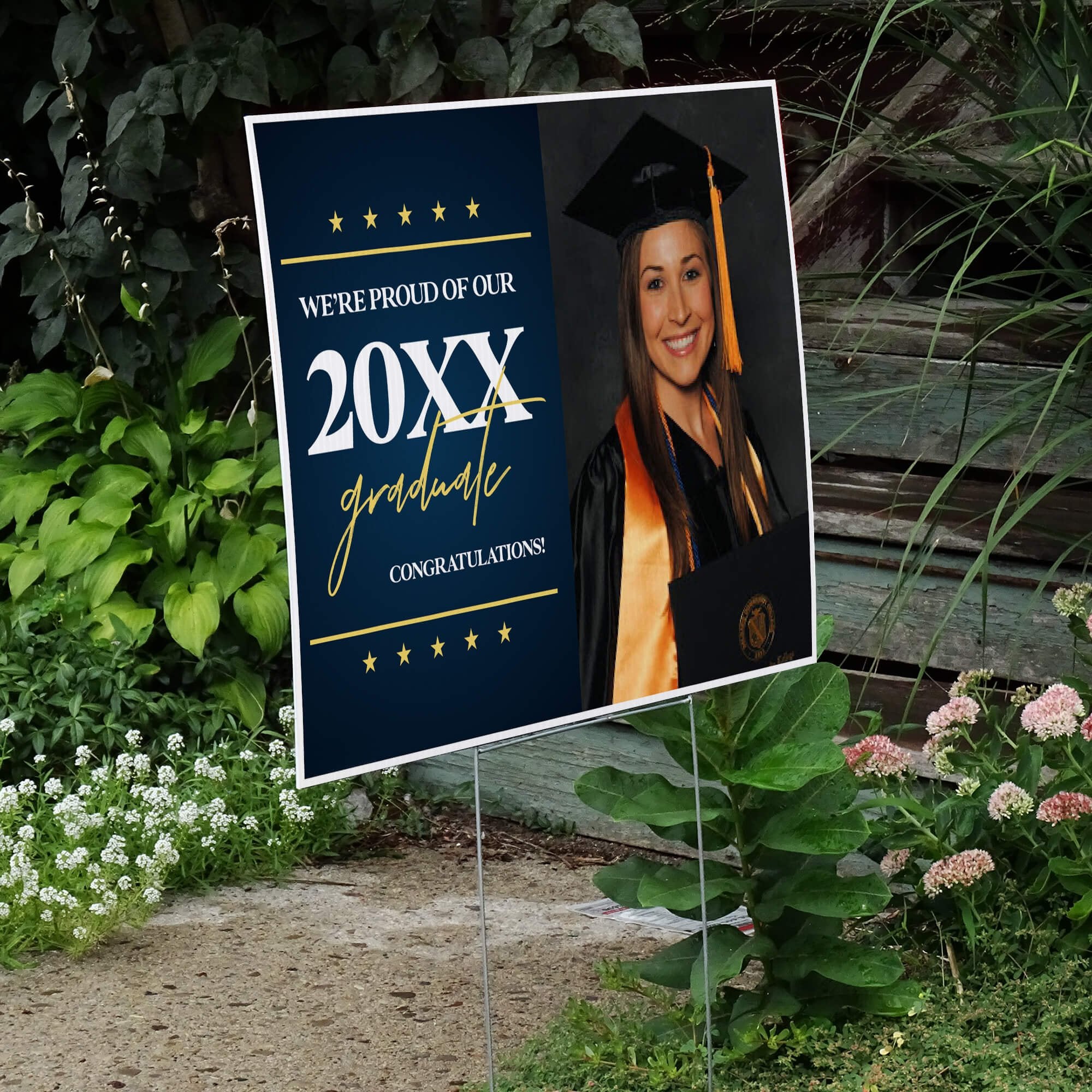 Star and Script custom graduation yard sign displayed by a pathway leading to stairs