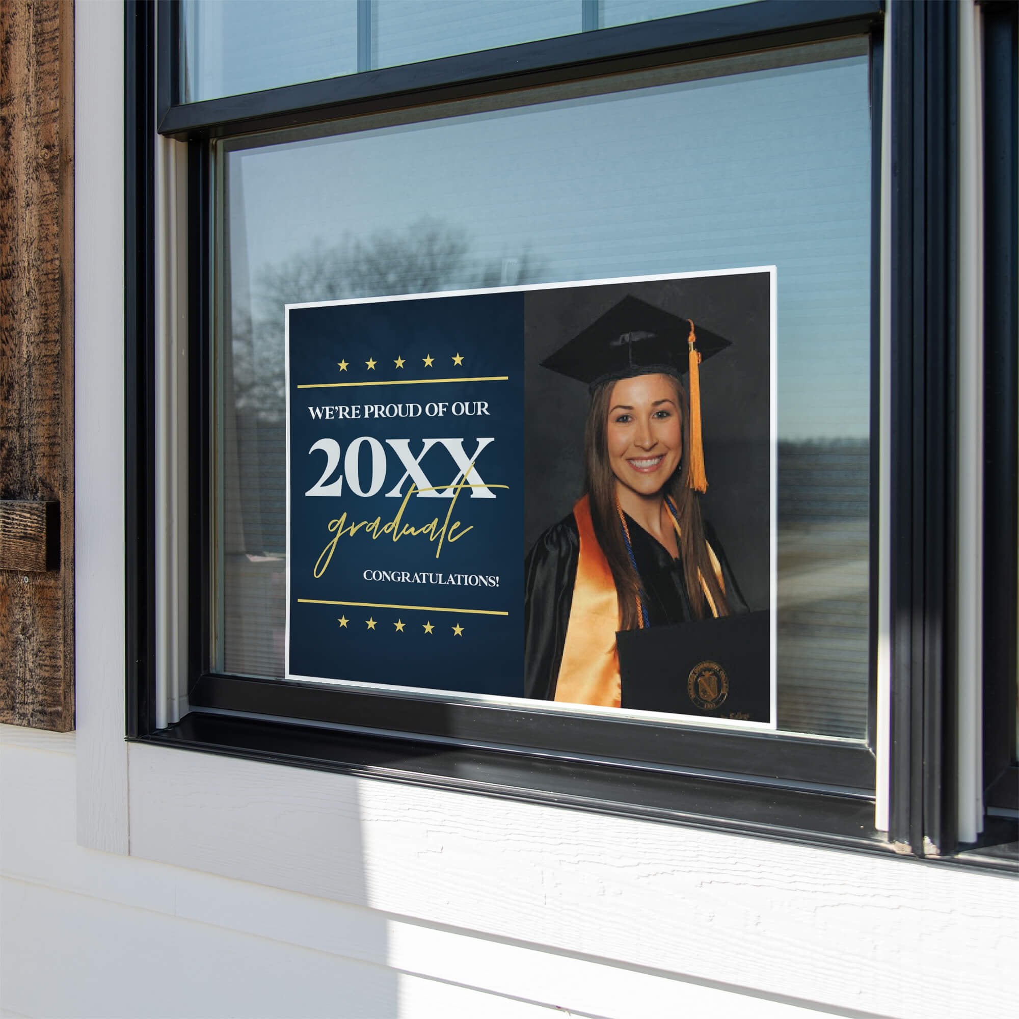 Star and Script custom graduation yard sign displayed in a window