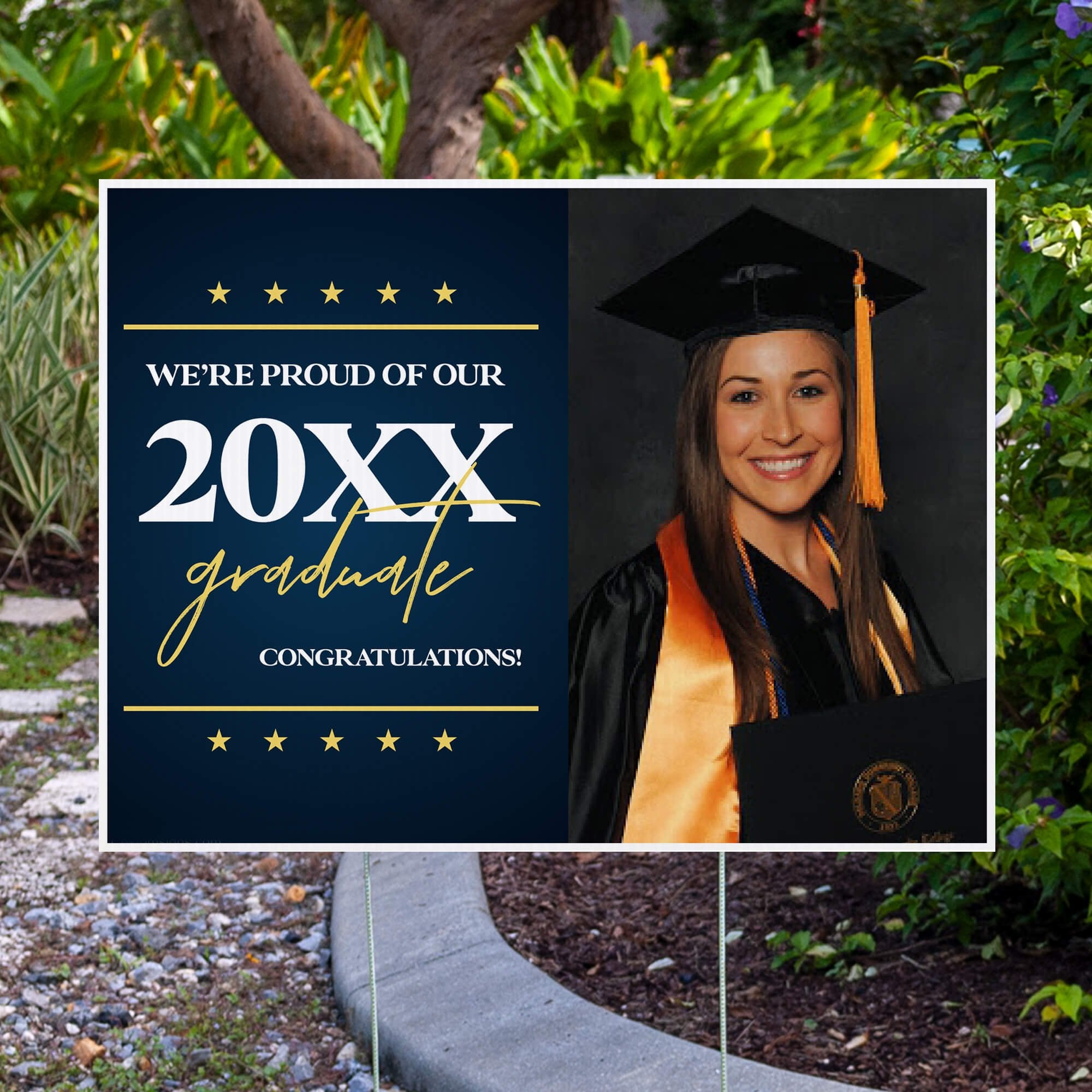 Star and Script custom graduation yard sign displayed in front of a fence
