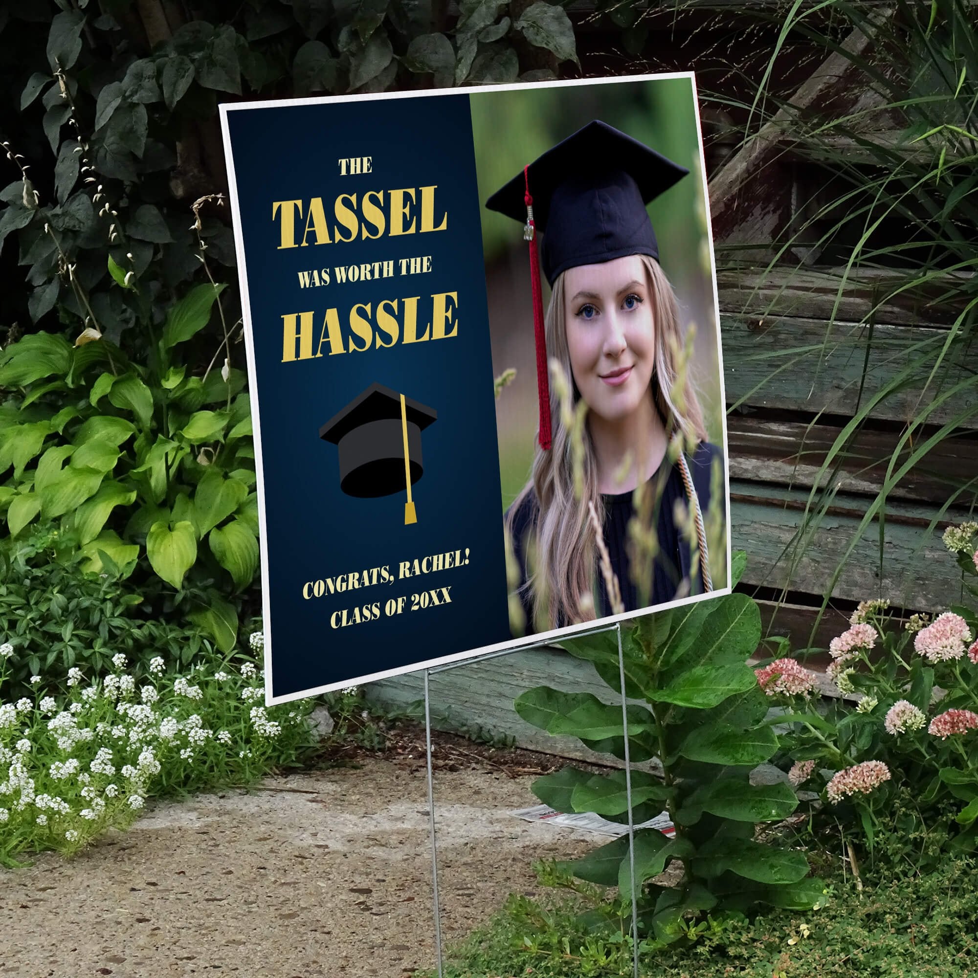 Tassel was worth the hassle graduation yard sign displayed next to stairs