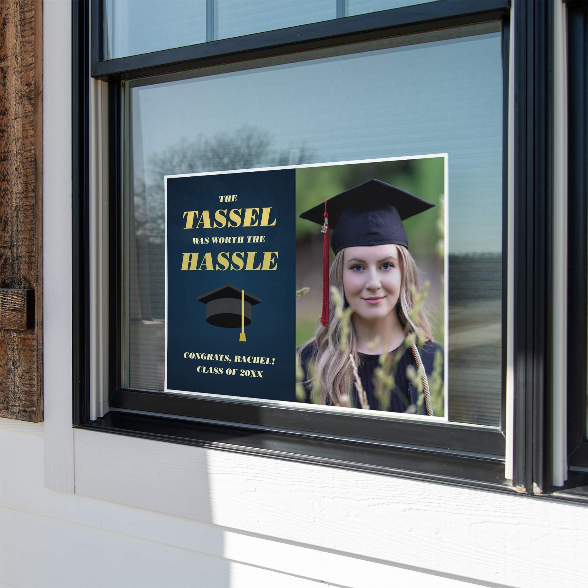 Tassel was worth the hassle graduation yard sign displayed in a window