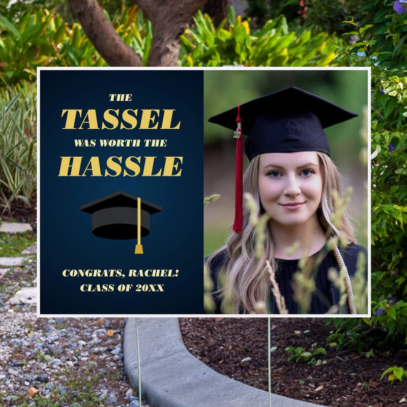 Tassel was worth the hassle graduation yard sign displayed next to pavement