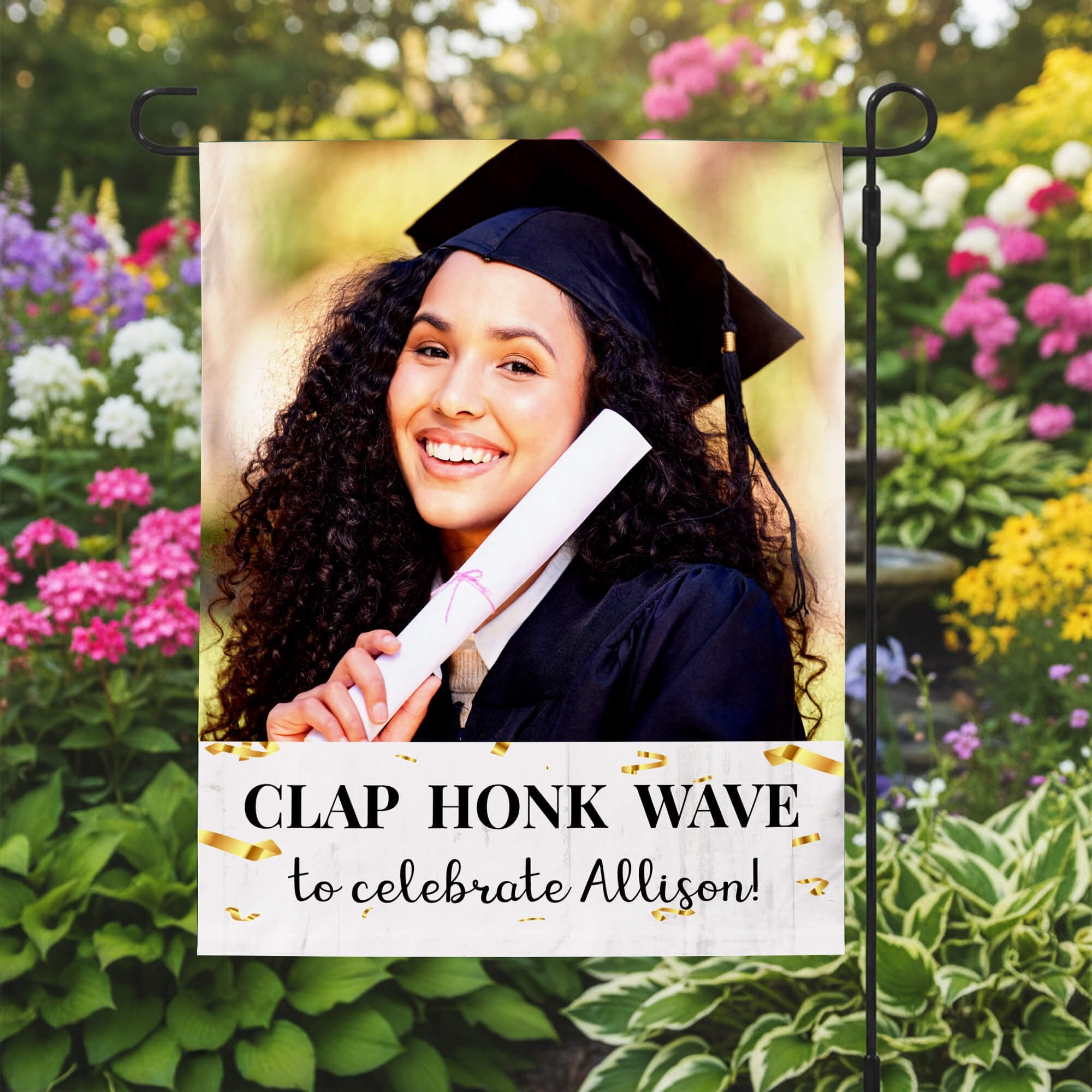 Graduation Clap Honk Wave Garden Flag in a garden