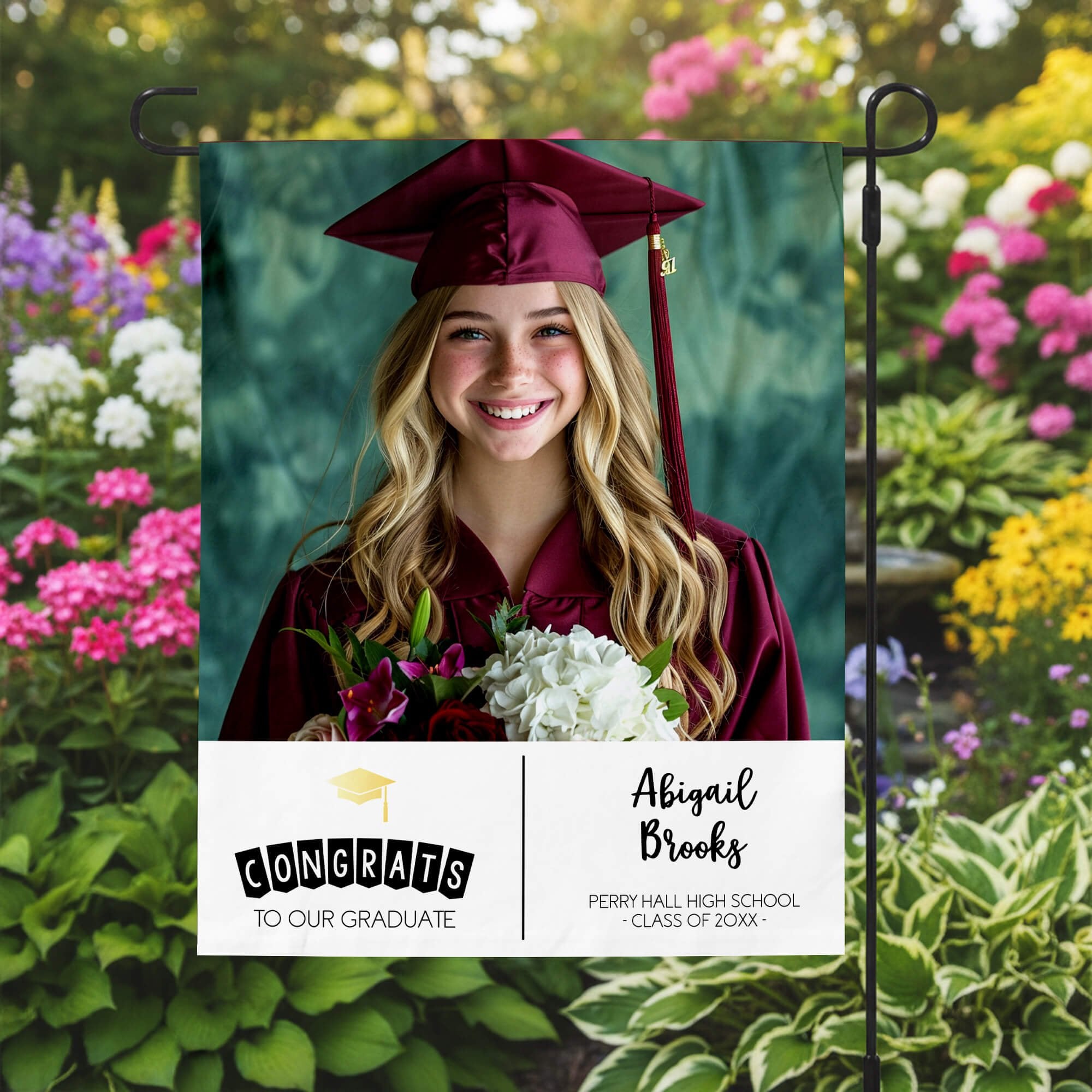 Graduation Gold Cap Garden Flag in a garden