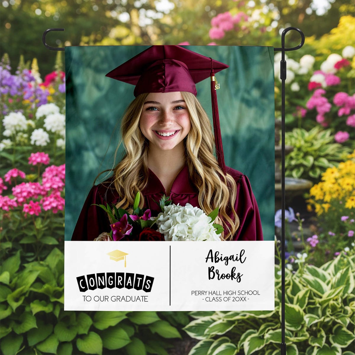 Graduation Gold Cap Garden Flag in a garden