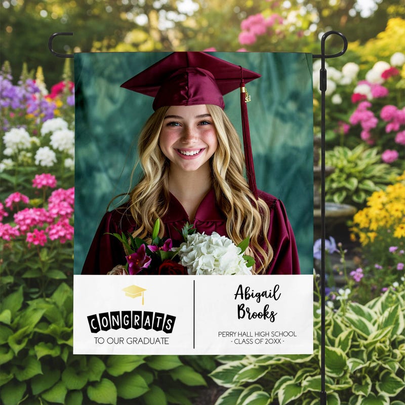 Graduation Gold Cap Garden Flag in a garden