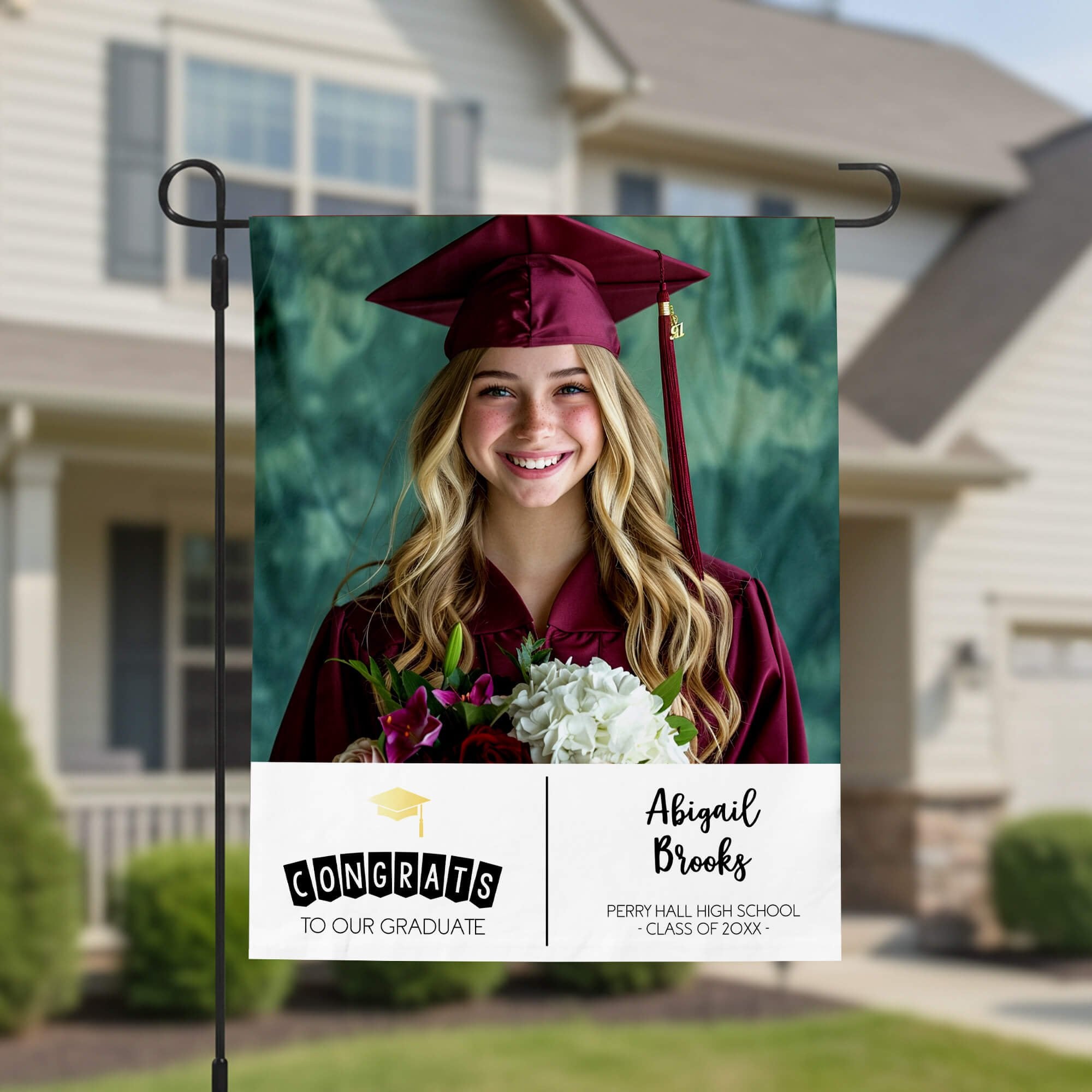 Graduation Gold Cap Garden Flag in front of a house