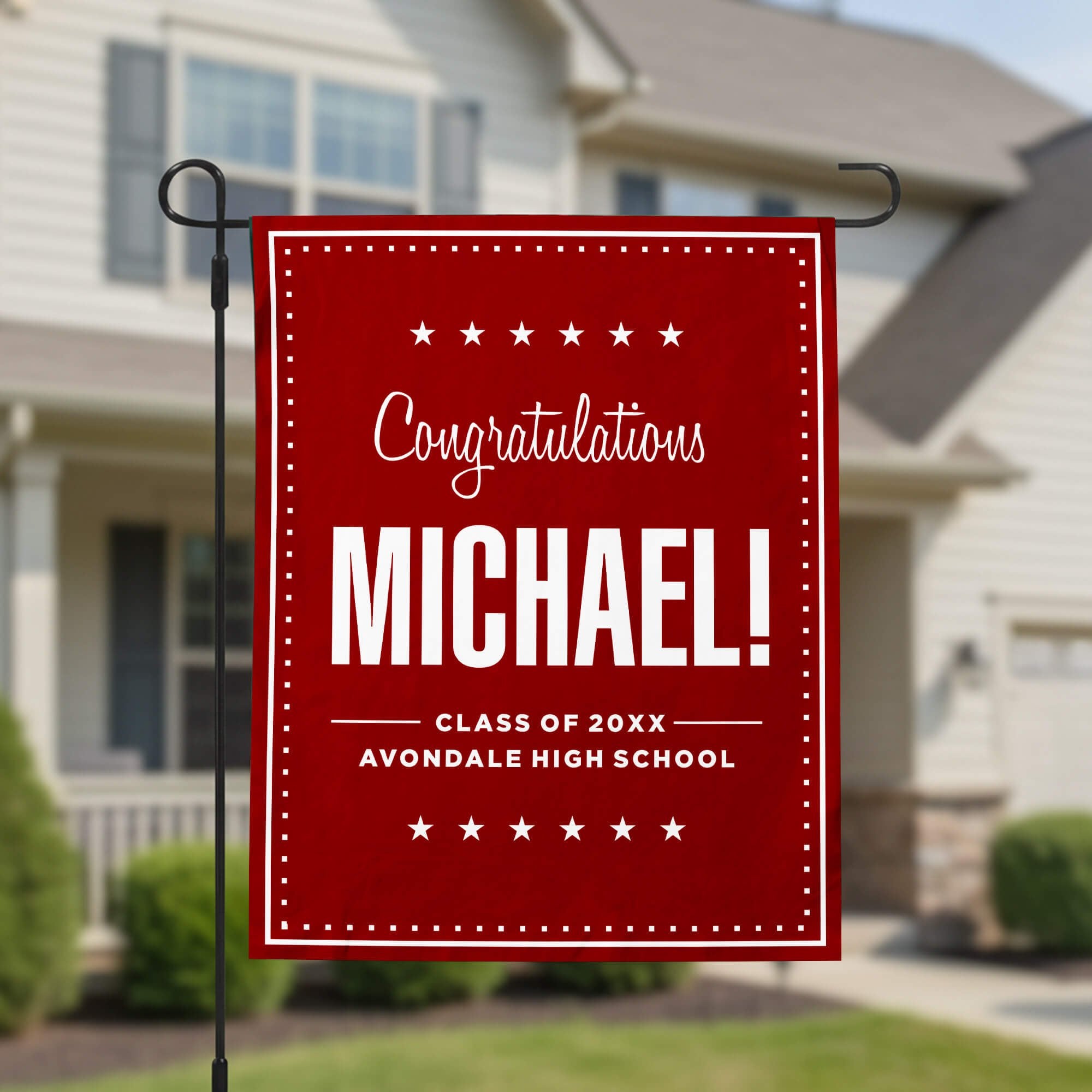 Graduation Bold Name Garden Flag in front of a house