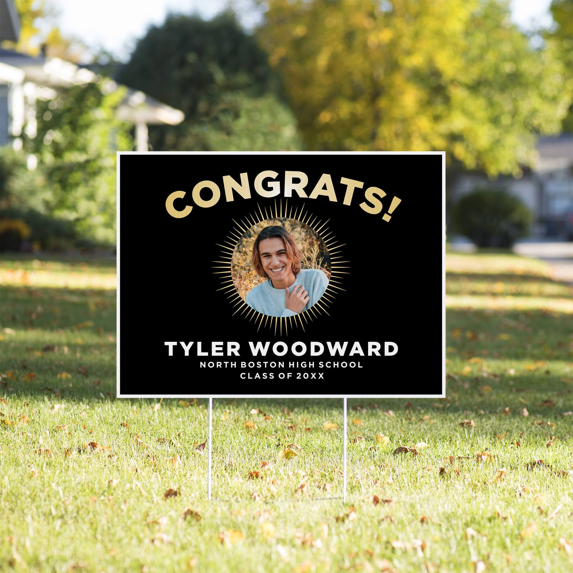 Sunburst graduation yard sign displayed in a yard