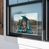 Full photo graduation yard sign displayed in a window