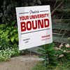 University logo graduation yard sign displayed by stairs