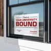 University logo graduation yard sign displayed in a window