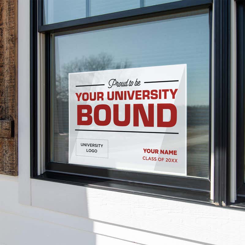 University logo graduation yard sign displayed in a window