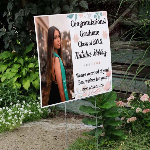 Floral Design and Note Graduation Yard Sign displayed by a pathway leading to stairs