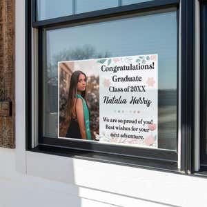Floral Design and Note Graduation Yard Sign displayed in a window