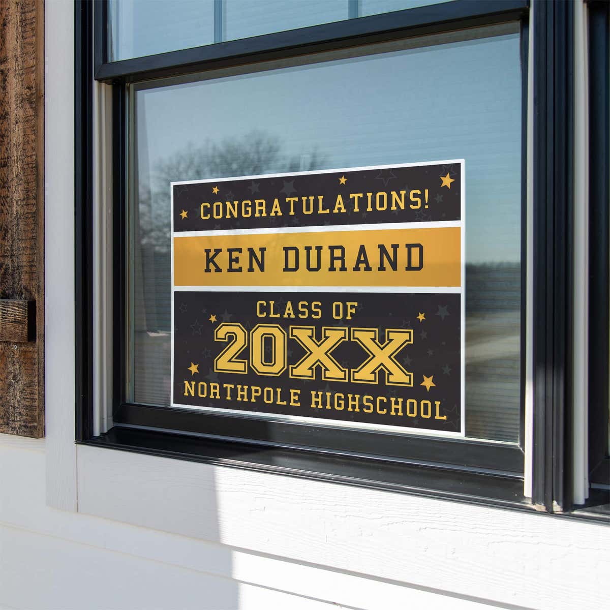 Gold Stars Graduation Yard Sign displayed in a window