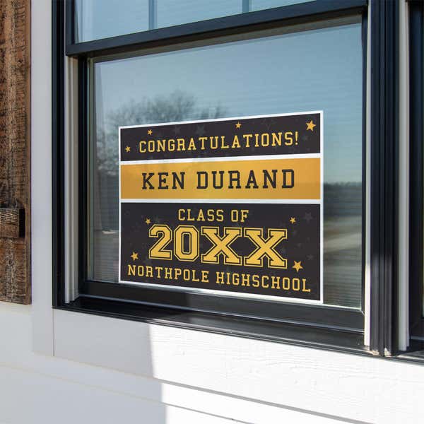Gold Stars Graduation Yard Sign displayed in a window