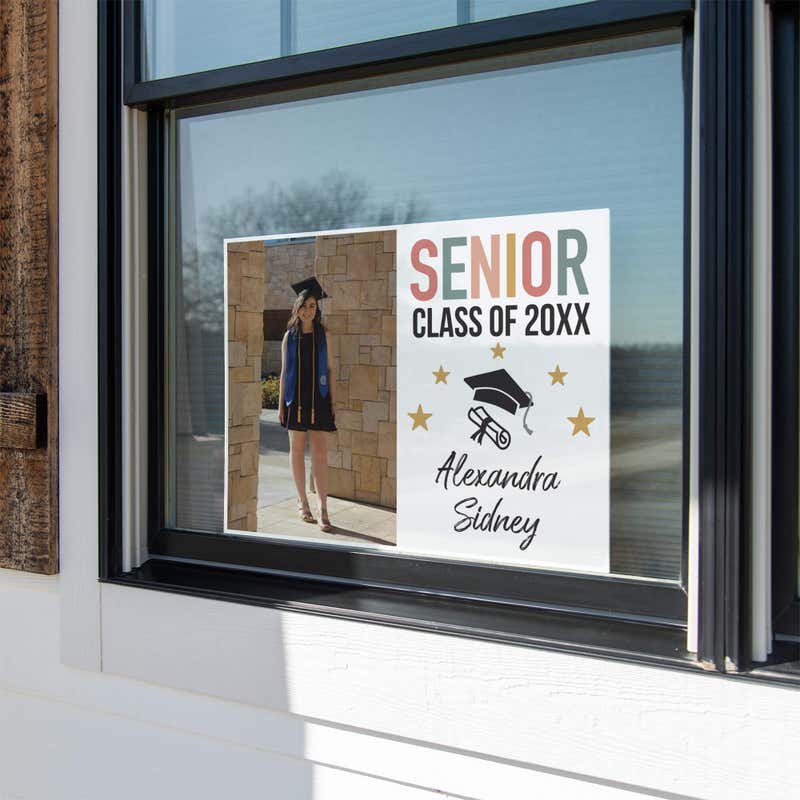 Pastels and Stars Graduation Yard Sign displayed in a window
