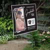 Picture Frame Graduation Yard Sign displayed by a pathway leading to stairs