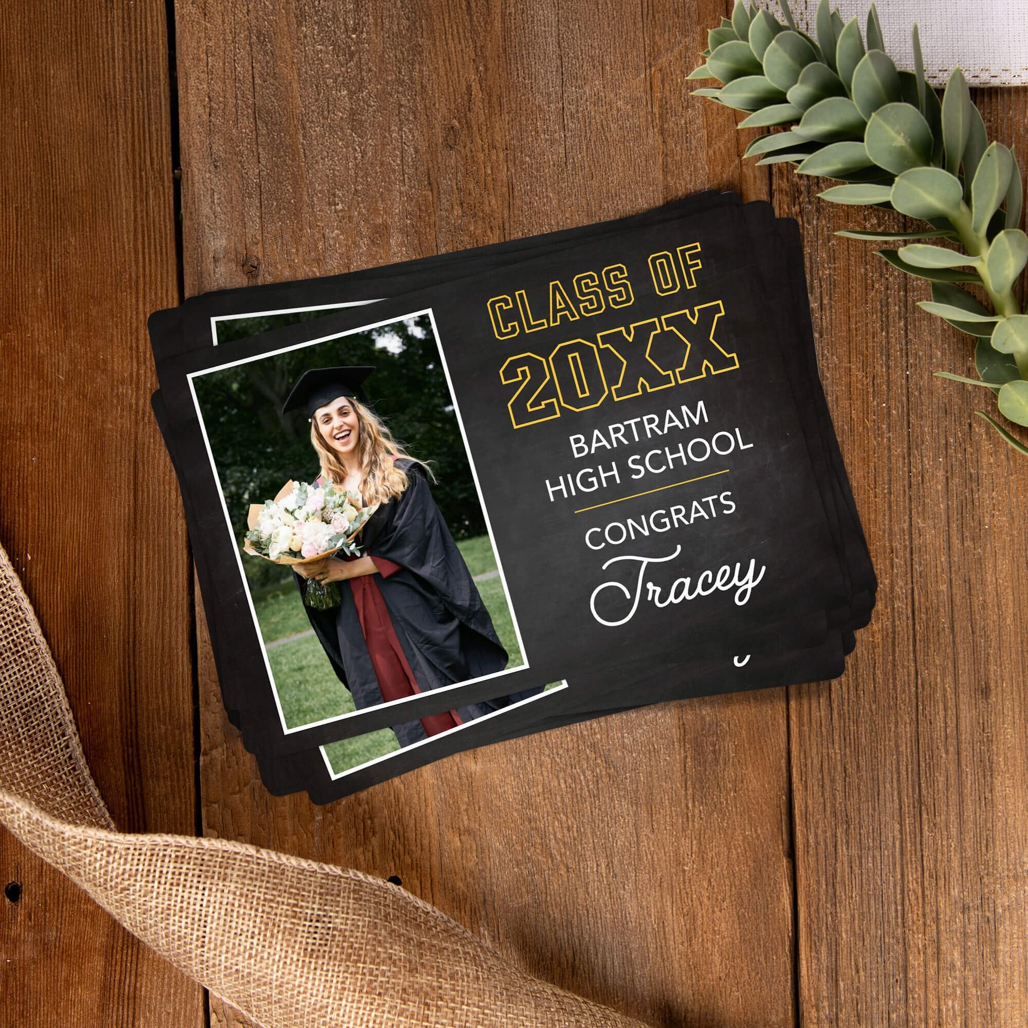 Stack of personalized Chalkboard Design Graduation Announcement photo magnets on a wooden table