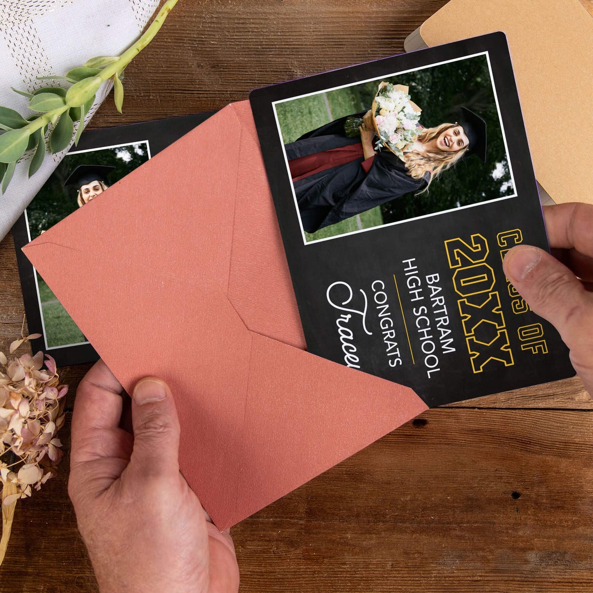 Personalized Chalkboard Design Graduation Announcement photo magnet being placed into a rose colored envelope
