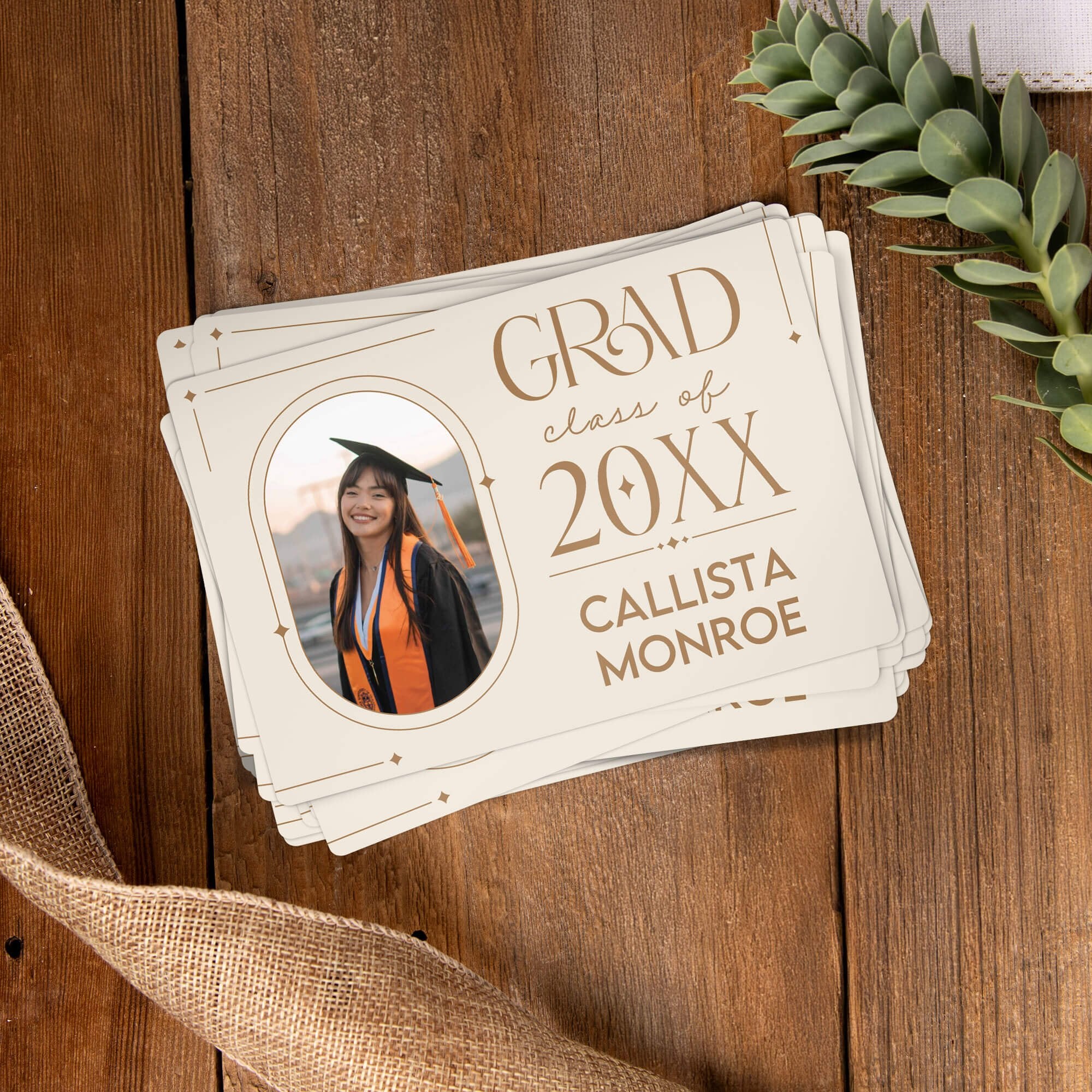 Stack of personalized Modern Minimalist Graduation Announcement photo magnets on a wooden table