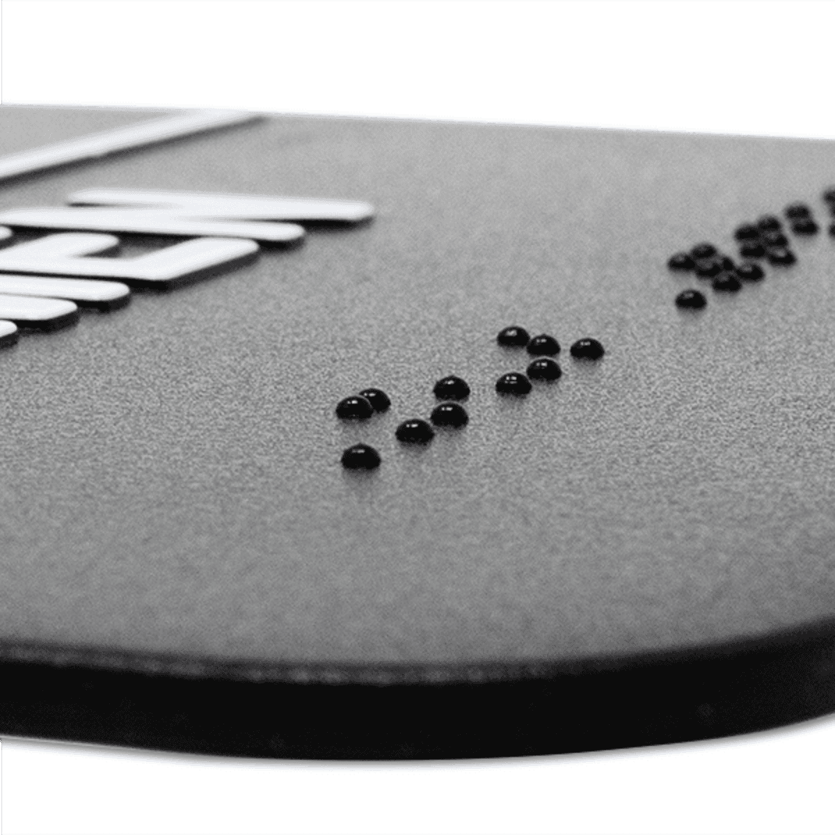 Close up of the braille on the sign