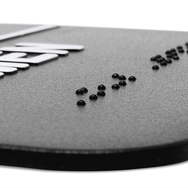 Close up of the Braille on an ADA sign