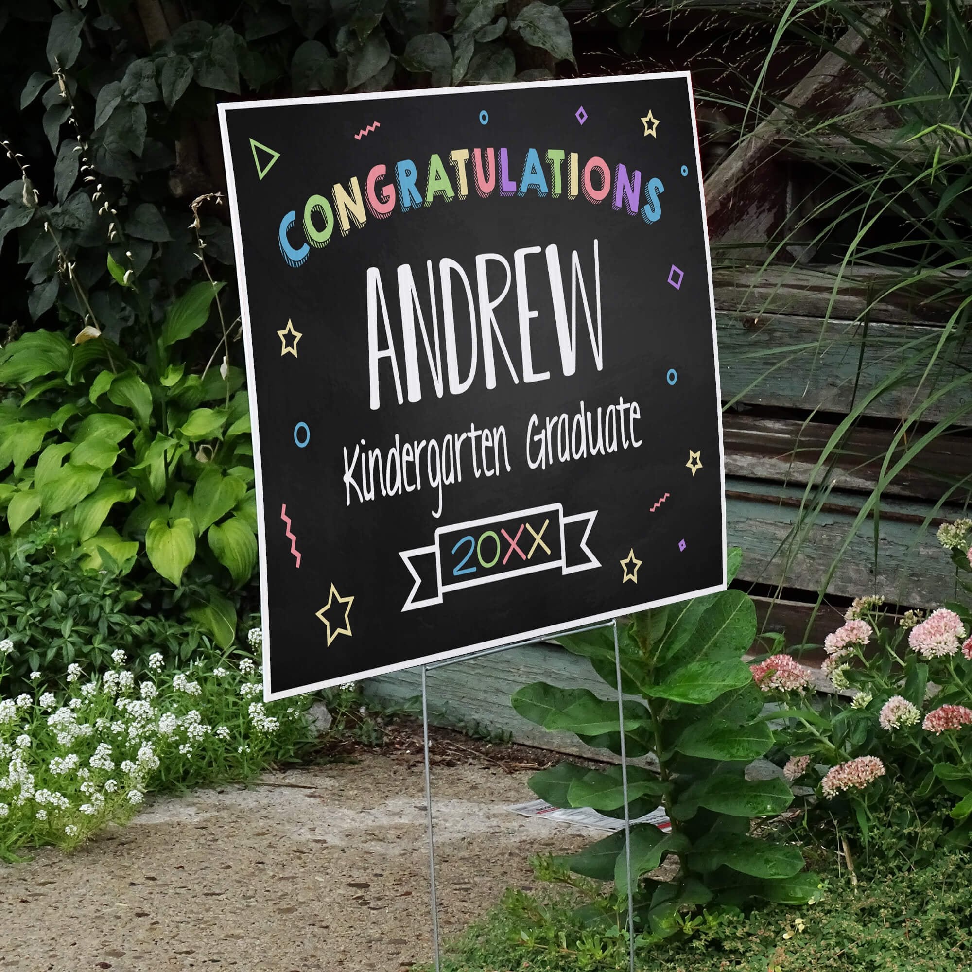 Colorful kindergarten graduation yard sign displayed next to stairs